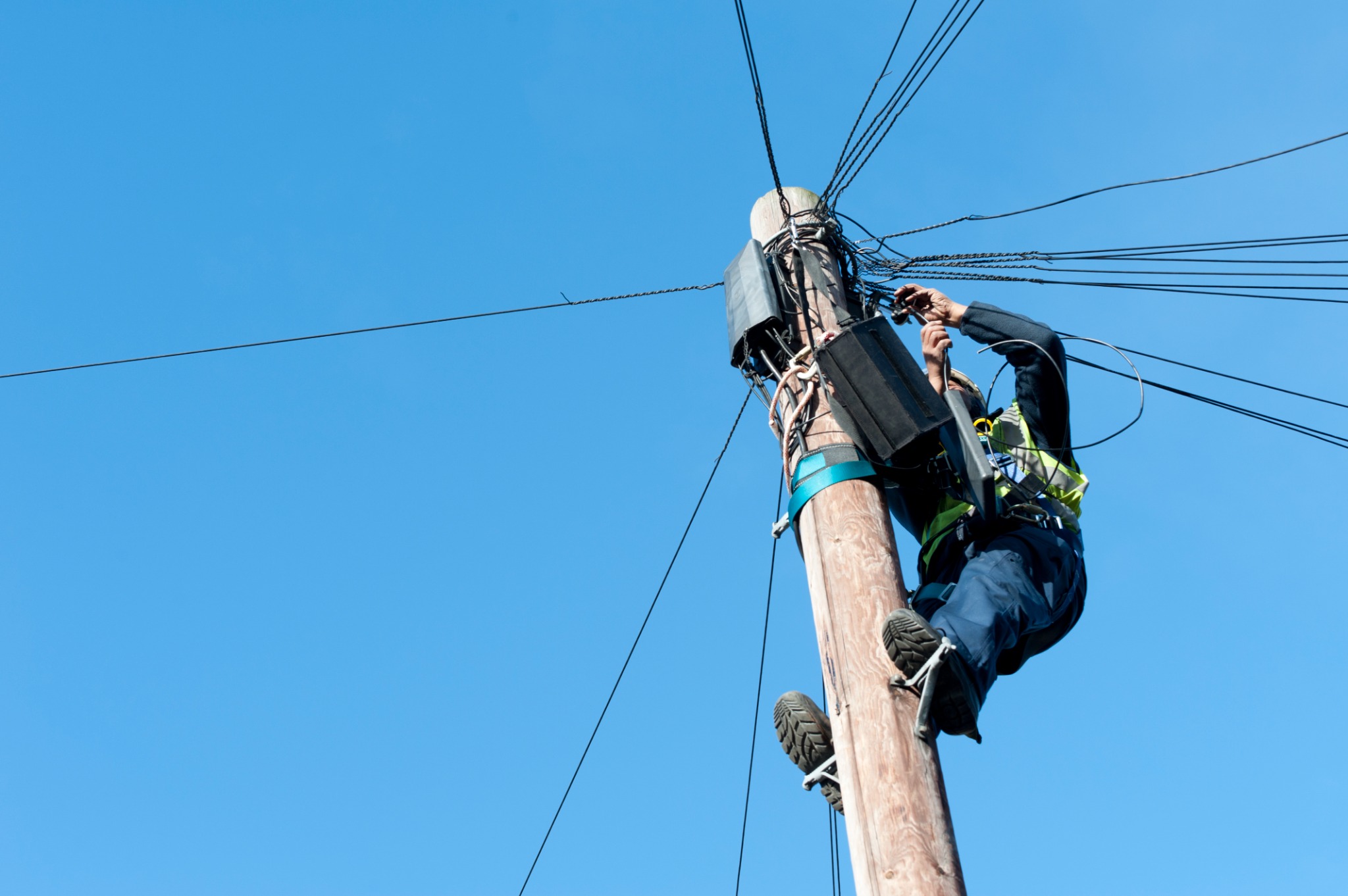 Field technician working from a utility pole